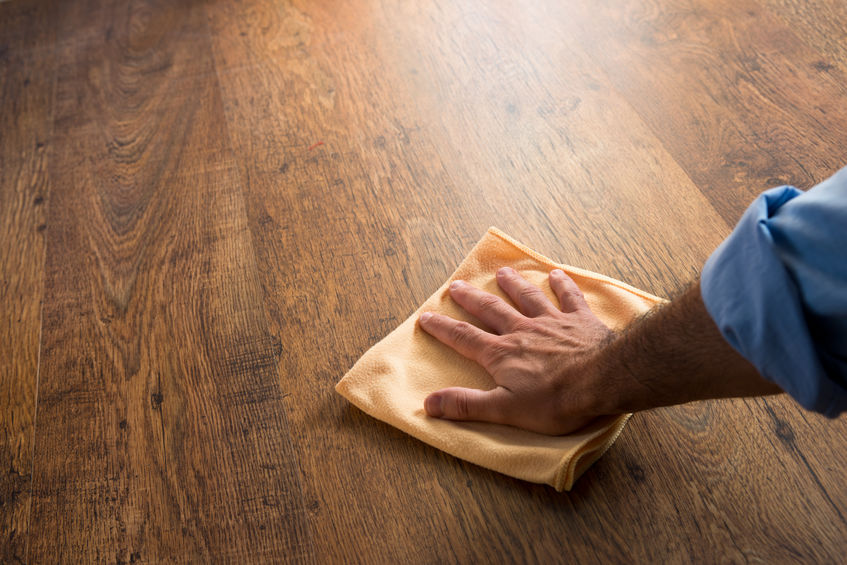 Hand cleaning a wood floor